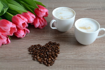 two cups of cappuccino with flowers