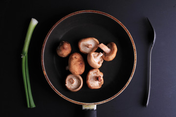 Shiitake mushrooms on black background. Fresh, raw, organic vegetables. Cooking, Healthy eating concept.