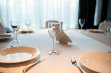 Empty plate, glasses and silverware set