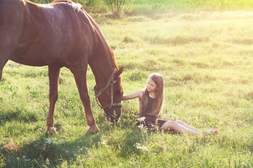 Girl stroking her horse