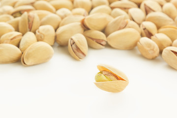 The pistachios on white background. The pistachio background.