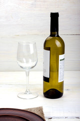 bottle of wine with a glass and a plate