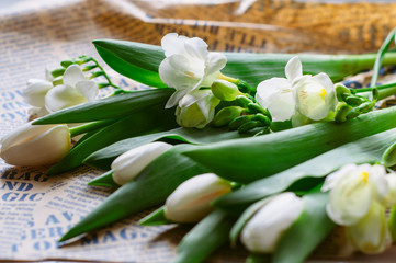 international women's day 8 march card. white flowers bouquet on neutral background. wooden white and vintage newspaper background. rustic style decoration