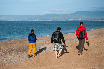 People walk on the pebble beach  Mediterranean Sea