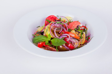 vegetarian salad with fmarinated tomatoes, onions, basil, top, close-up