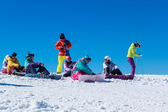 a crowd of young people on a snowy mountain
