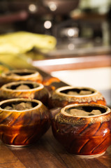 Ceramic pots for roasting on a kitchen table