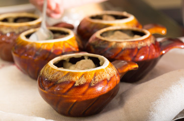 Ceramic pots for roasting on a kitchen table