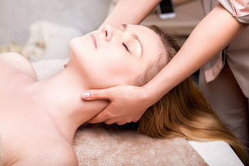 Caucasian pretty  woman having massage in spa salon