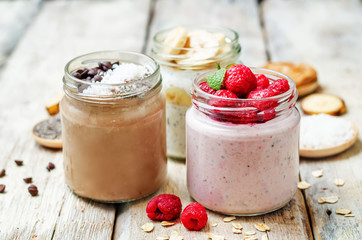 set overnight oats with berries, coconut, peanut butter, Chia se