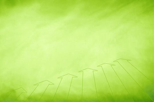 Conceptual simple eco green arrows on blurred yellow green background. Eco green concept arrows background with place for text message.