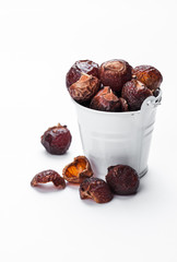 soap nuts on a white background in a white bucket. Care products. natural, organic