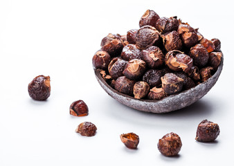 soap nuts on a white background in the coconut. Care products. natural, organic