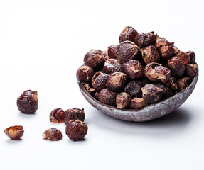 soap nuts on a white background in the coconut. Care products. natural, organic