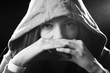 cool teenager girl or young woman on her 20s posing cool showing attitude wearing hood on