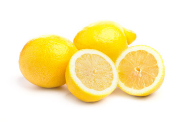 Fototapeta na wymiar Whole and sliced fresh lemons on on white, DOF