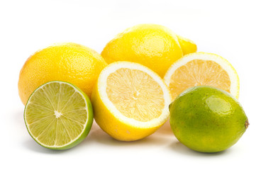 Whole and sliced fresh limes and lemons on on white, DOF
