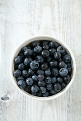 blueberry on wooden surface