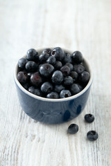 blueberry on wooden surface