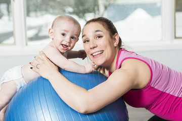 Mother with child boy doing fitness exercises