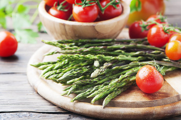 Uncooked fresh asparagus with tomato