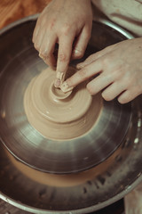 child working on potter's wheel