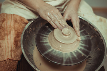 child working on potter's wheel
