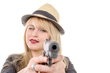 young pretty woman pointing a gun at the camera with one hand,