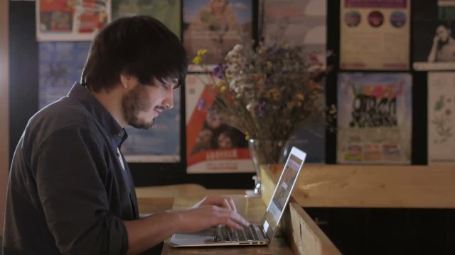 Young Entrepreneur Freelancer Working using a Laptop and in Coworking