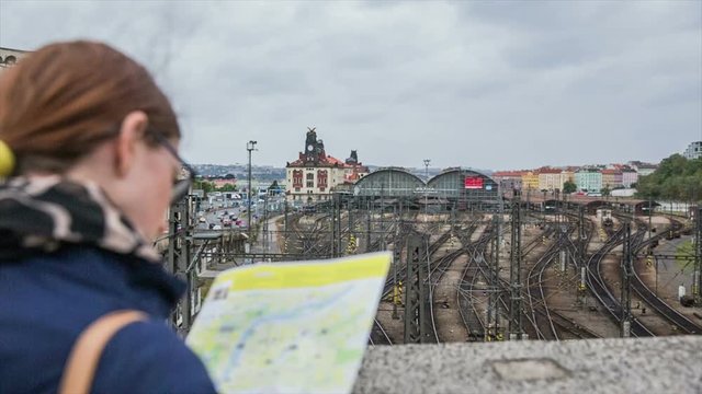 Tourist at Prague rail station looking at map