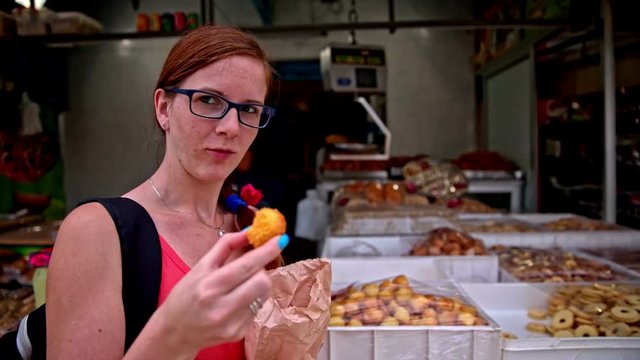 Woman buying cookies at marketplace