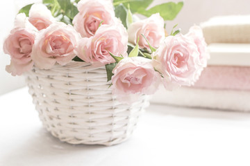 Beautiful, pink roses in a white basket close up
