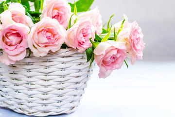 Beautiful, pink roses in a white basket close up