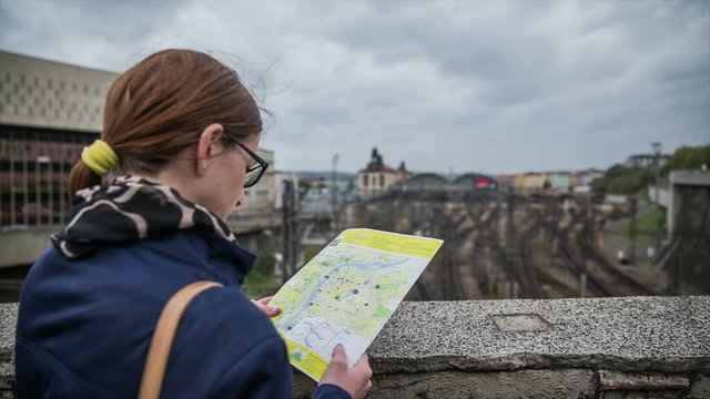 Woman look at map above rail station