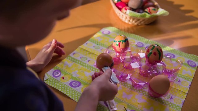 Boy draws a blue line around an egg close up