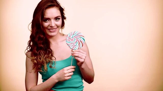 Woman smiling girl with lollipop candy 4K