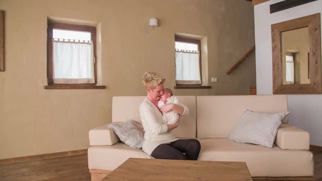 Big living room with mother petting baby