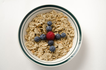 Bowl of quinoa-chia cereal decorated with blueberry and strawberry