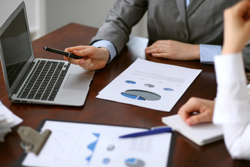 Close up  of unknown  business people at meeting discussing financial results