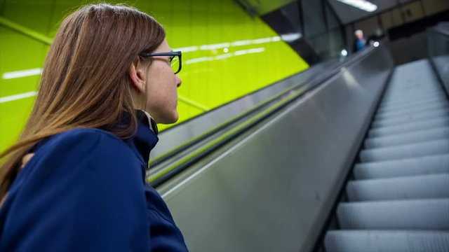Woman ride up with escalator