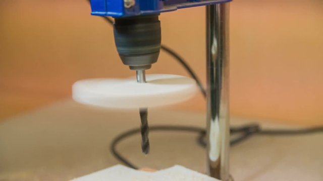 Wood spinning on drilling machine close up