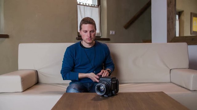 Photographer checking medium format retro camera
