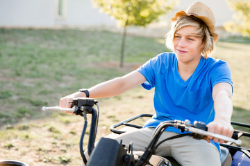 Boy riding farm truck in vineyard