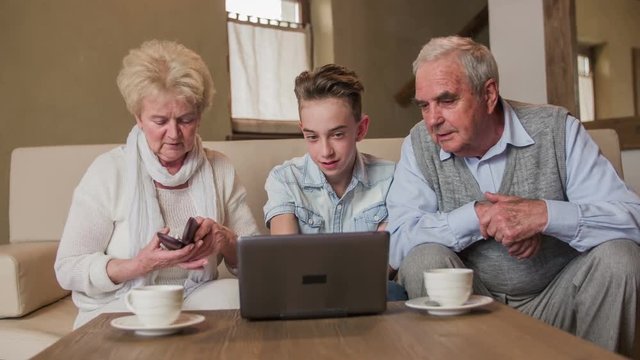 Grandparents looking on small laptop screen