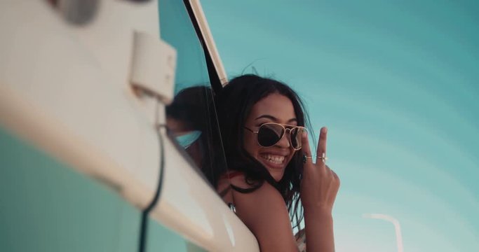 Hipster young adult girl showing peace sign with hand