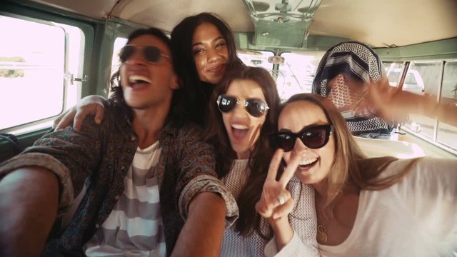Hipster young women taking selfie inside a vintage van