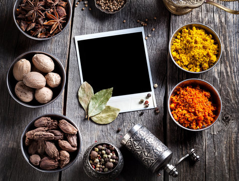 Spices and blank photo at the table