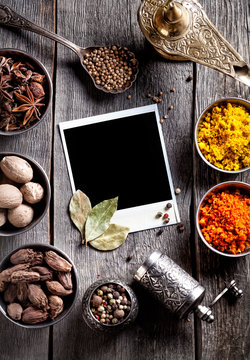 Spices and blank photo at the table