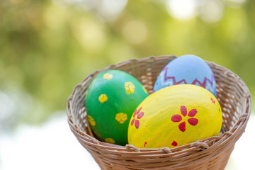 close up of colored easter eggs in basket