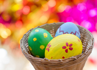 close up of colored easter eggs in basket